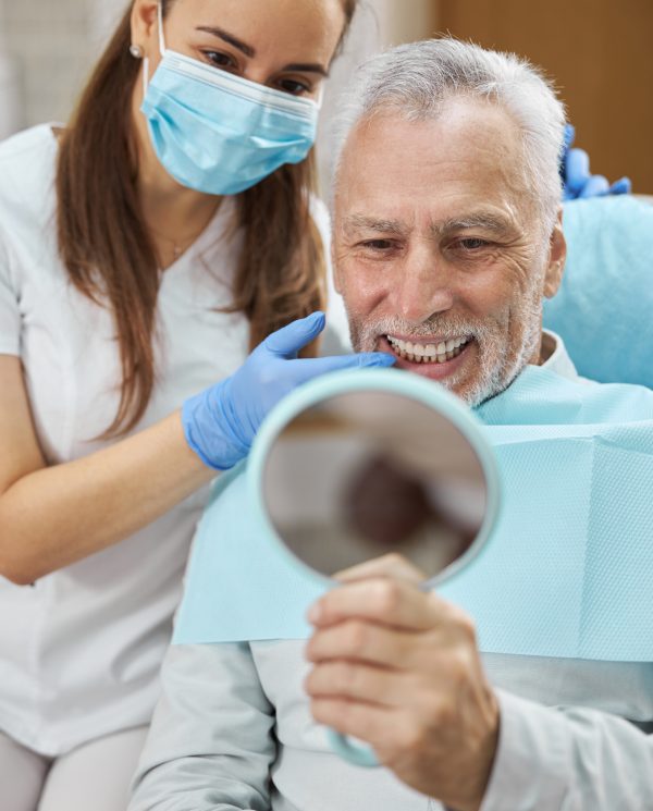 man smiling in dentists chair